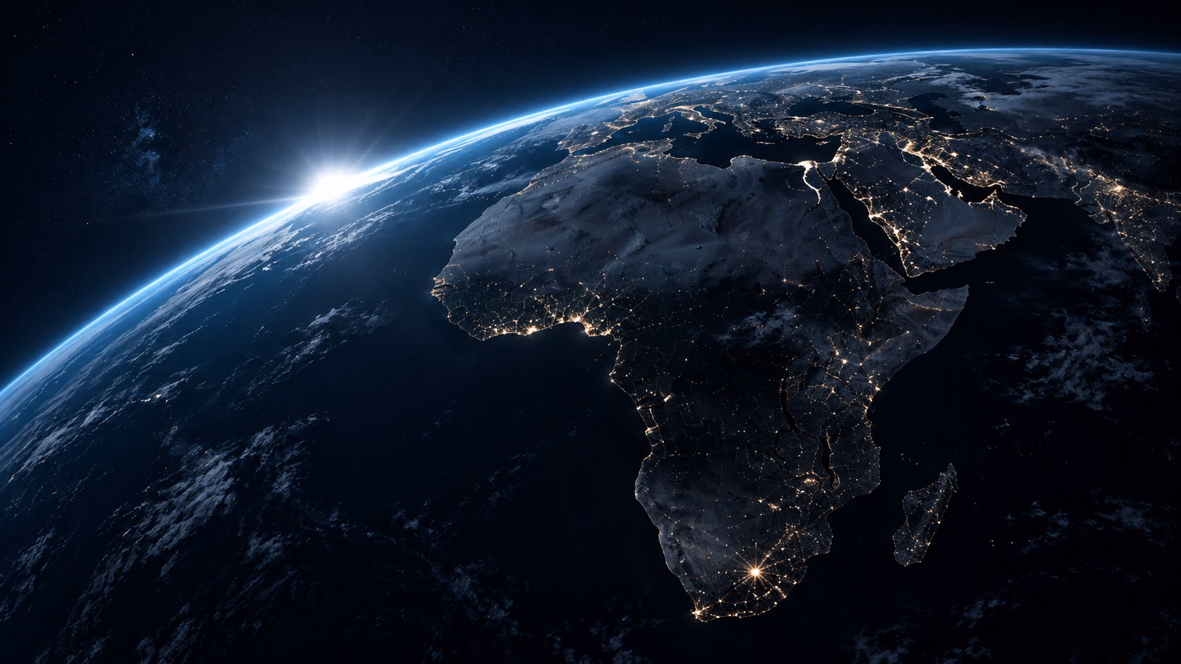 Africa seen from orbit at night, city lights tracing the coasts and the interior